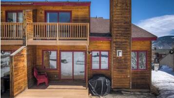 Enjoy a scenic view from the upper-level balcony, featuring large windows and a covered outdoor seating area.