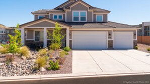 A two-story house with a garage, a stone foundation, and a landscaped front yard with small trees and shrubs. - Casa at Ladera Resort, Private Home! (Washington)
