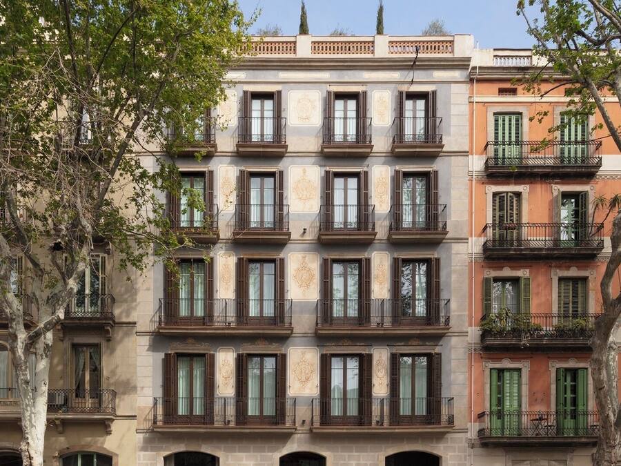 A multi-story building with balconies and windows, featuring a classic architectural style.