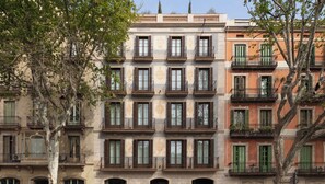 A multi-story building with balconies and windows, featuring a classic architectural style.