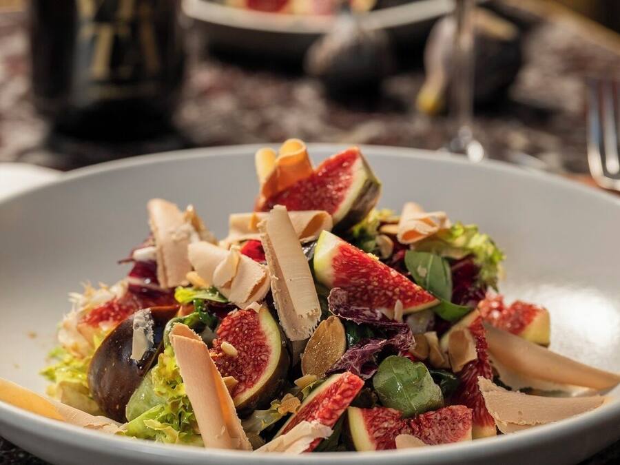 A plate of salad with various ingredients.