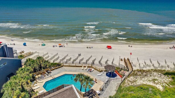 A beach resort with a swimming pool, beach umbrellas, and a view of the ocean. - Fall 2026 Rate Drop! 3 BR/3 BA Cottage -Dog Friendly! (Port St. Joe)