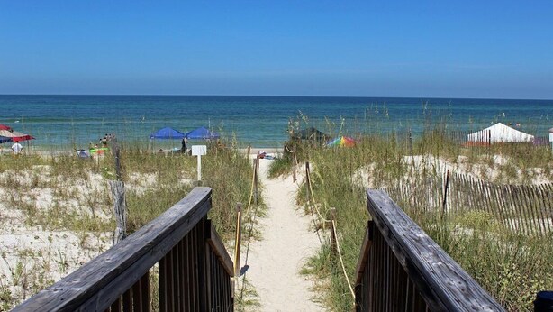 A beach path leading to the ocean with beach umbrellas and a wooden boardwalk. - Fall 2026 Rate Drop! Gulfview, 2 BR/2.5 BA, Great Location! (Port St. Joe)