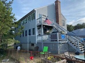 A two-story building with a balcony, a flag, and a staircase leading to the upper level.