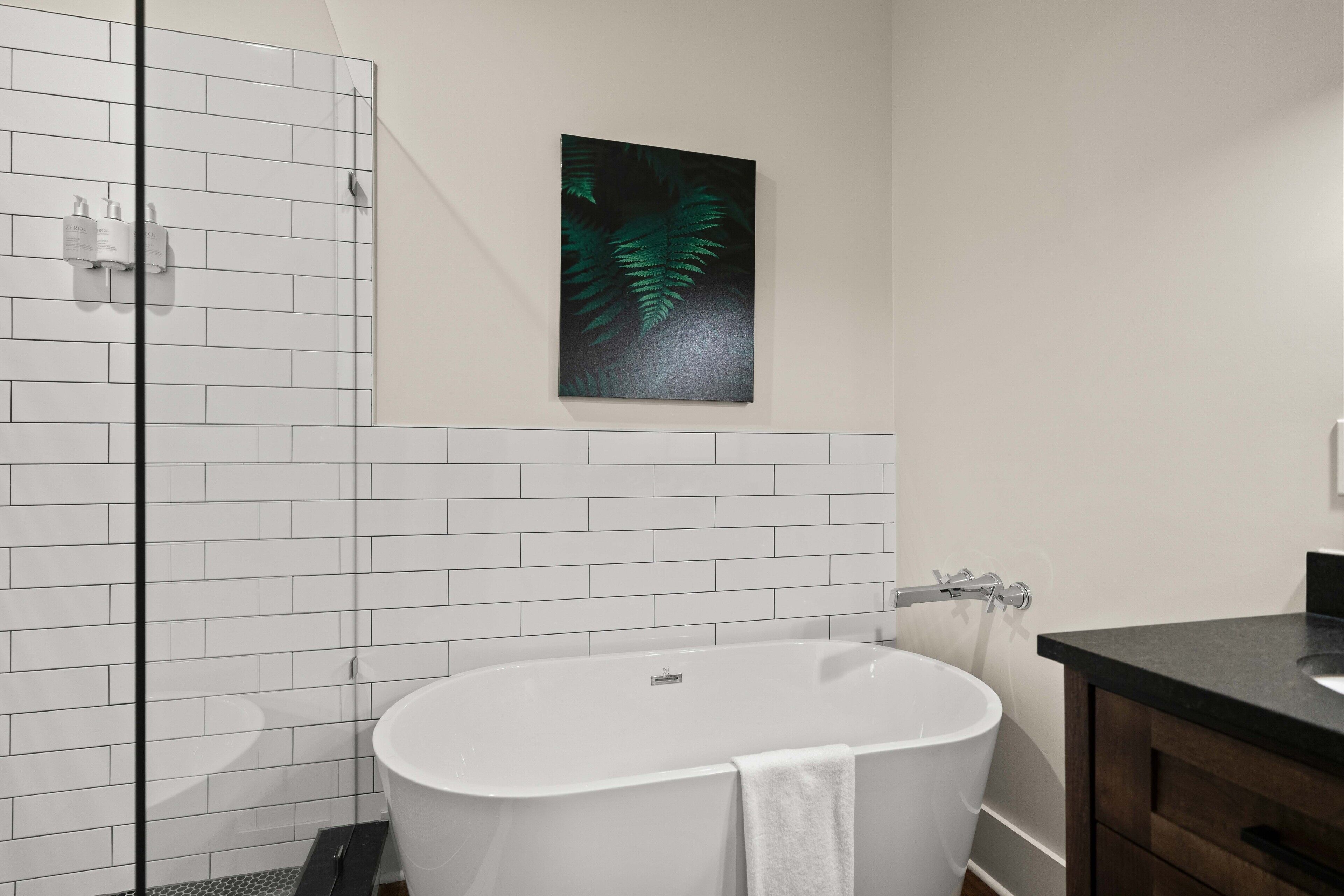 suite, 1 king bed with sofa bed | bathroom | separate bathtub and shower, hair dryer, towels