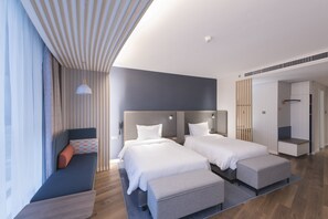 Minibar, escritorio, cortinas blackout y tabla de planchar con plancha