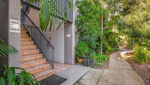 A staircase leading to a building labeled "UNITS 23 to 28" with a "NO SMOKING" sign. - Baden 28 - Rainbow Shores. Top Floor Unit. Air conditioned. Walk to Beach (Rainbow Beach)