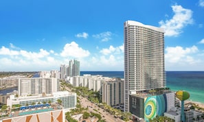 A high-rise hotel with a view of the ocean, multiple buildings, and a road with vehicles. - OCEANFRONT BUILDING; rooftop pool, 1 Bd condo with OCEAN VIEWS GUARANTEED  (Hollywood)