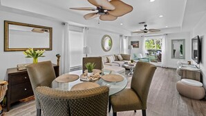 A spacious living room with a glass coffee table, comfortable seating, and ceiling fans. - 3 OR 6 bdrms  Villa - 1 minute from the beach ADD GUESTHOUSE (Boca Raton)
