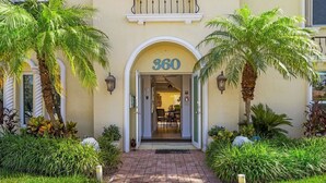 A building entrance with the number 360, a paved pathway, and palm trees. - 3 OR 6 bdrms  Villa - 1 minute from the beach ADD GUESTHOUSE (Boca Raton)