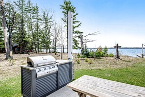 Outdoor dining - Dog-friendly, lakefront house with beach access, dock, AC, W/D, patio, & firepit (St. Germain)