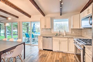 Enjoy cooking in this well-lit kitchen with a stainless steel stove, dishwasher, and oven.