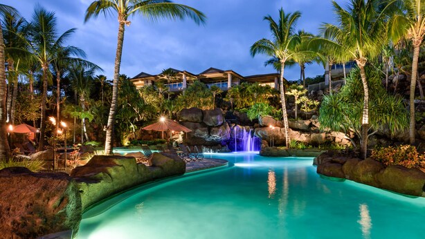 A resort with a swimming pool, palm trees, and a waterfall. - I.P.M PRESENTS: HOOLEI 93-1: 3 BEDROOMS + OFFICE. FLEXIBLE CANCELATION POLICY (Kihei)