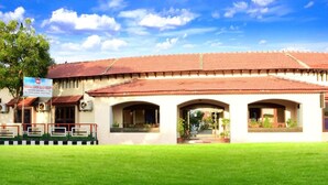 A building with a tiled roof and arched windows, labeled as "Karaka Ashok Beach Resort." - Karaikal Ashok Beach Resort (Karaikal)