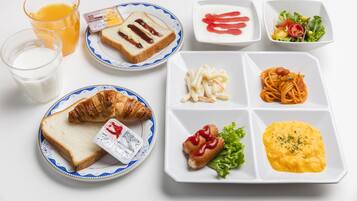 A breakfast tray with toast, croissant, scrambled eggs, pasta, and a hot dog.