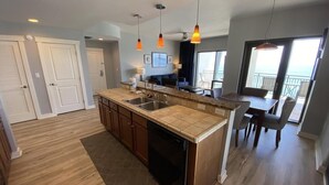 A modern kitchen with a central island, built-in appliances, and pendant lighting. - Beautiful Beachfront luxury living at its best (Panama City Beach)