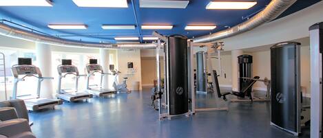 A gym with treadmills, a stationary bike, and weight machines.