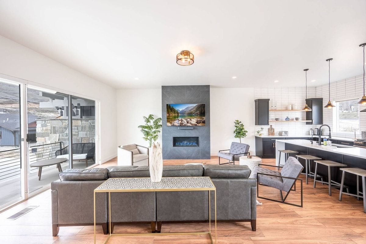 The welcoming open concept floor plan is filled with a refined combination of matte black, chic white and warm woods to create a chic interior