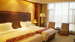 A hotel room with two beds, a desk, a chair, and a large window with curtains. - Huitang Zilongwan Hot Spring Holiday Hotel (Changsha)