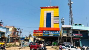 A multi-story building with a prominent yellow and blue facade, featuring signage for 'SENTHILTONS' and 'VASANTHA BHAVAN'. - Royal Residency (Sriperumbudur)