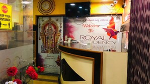 A reception desk with a sign reading "Welcome to Royal Residency." - Royal Residency (Sriperumbudur)
