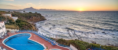 Seasonal outdoor pool, pool umbrellas, pool loungers