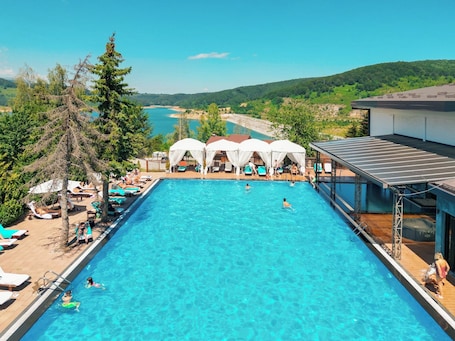 Indoor pool, outdoor pool, pool umbrellas, pool loungers. Radika Rezort