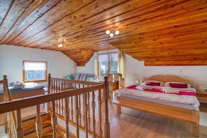 A wooden interior with a bed, a sofa, and a staircase. - Pool & Wellness Chalet Sunshine (Vransko)