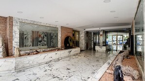 A spacious lobby with marble flooring, a large decorative wall, and a modern reception area. - N&J - SUNRISE TERRACE - Close sea - Terrace 30m² (Niza)