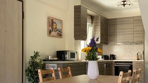 A modern kitchen with wooden cabinets, a dining table with chairs, a microwave, and a no smoking sign. - Villa Emerald - brand new house few minutes from the beach (Nikiti, Sithonia)