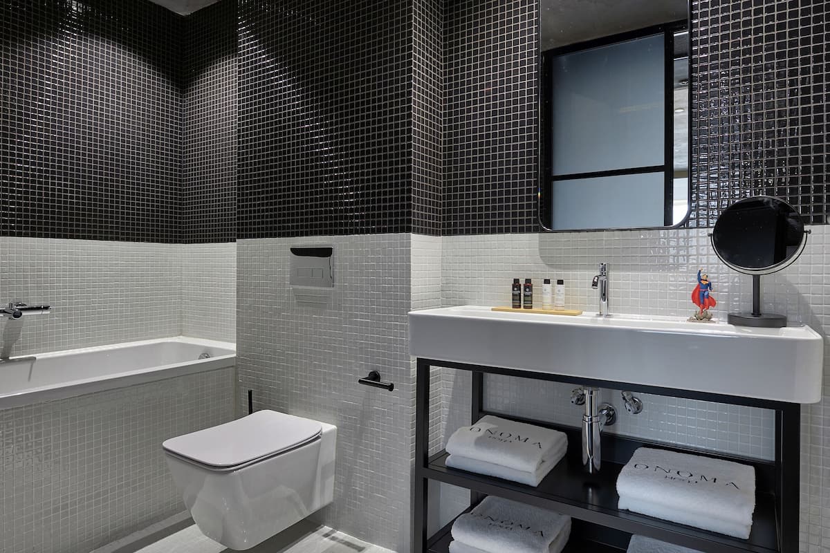 signature suite | bathroom | eco-friendly toiletries, hair dryer, bathrobes, slippers