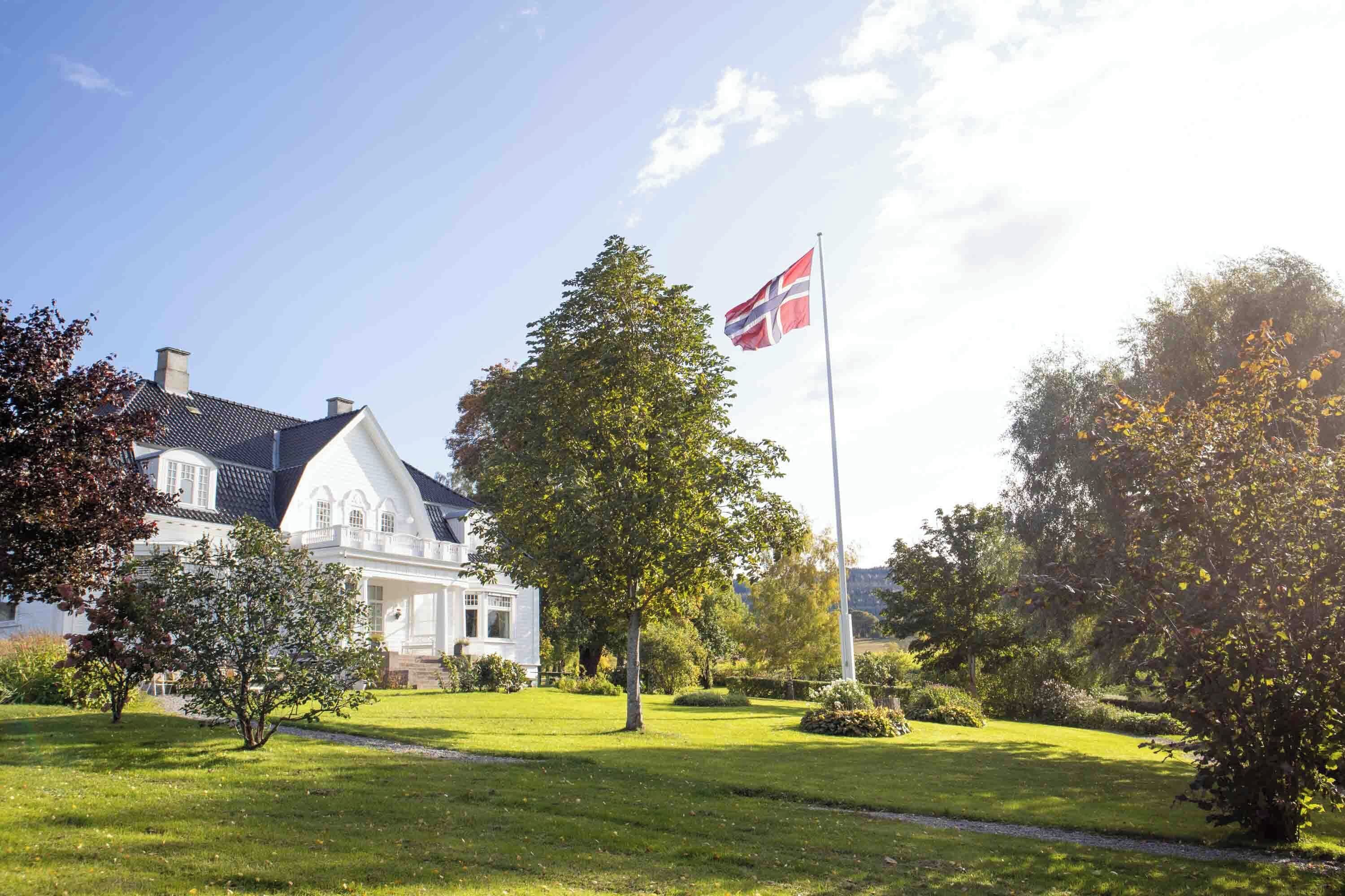 A large white building with a flagpole and a flag.