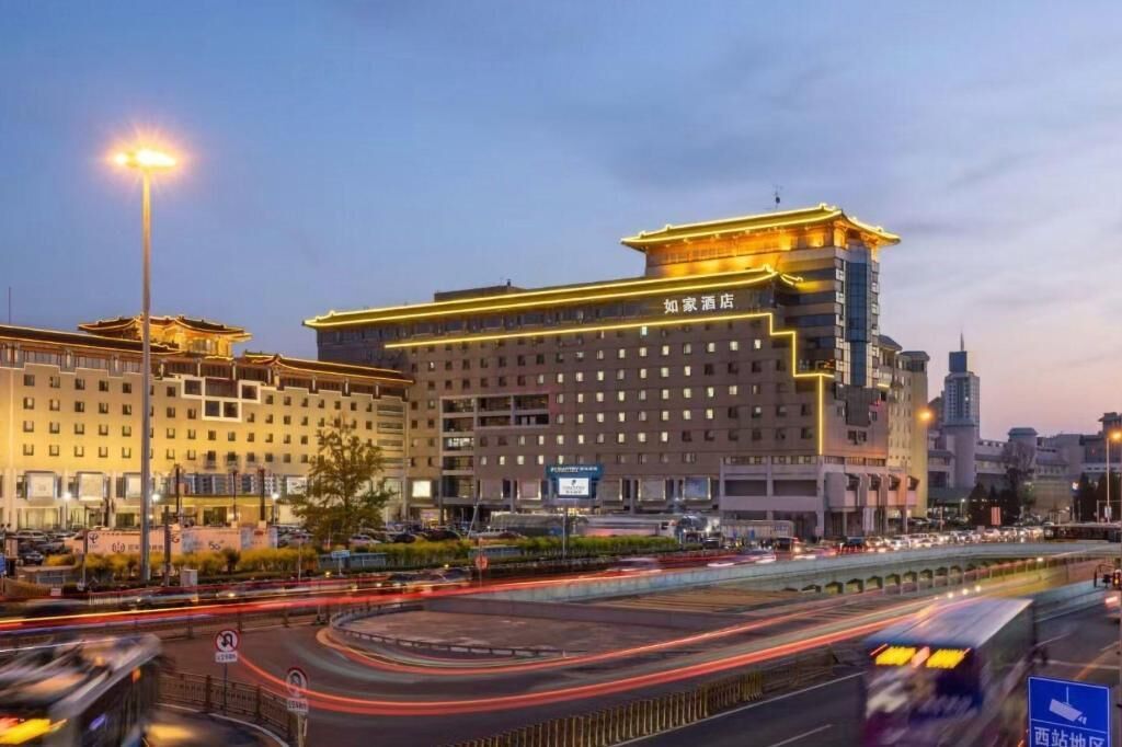 A hotel with a modern design, featuring a prominent entrance and multiple floors.