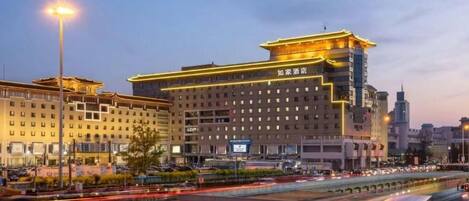 A hotel with a modern design, featuring a prominent entrance and multiple floors.
