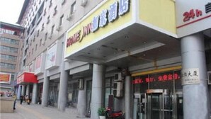 A hotel entrance with a sign indicating 24-hour service. - Home Inn Hotel Beijing West North Plaza (Beijing)