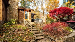 A stone staircase leading to a wooden building with a covered outdoor seating area. - Cozy Cottage - Perfect Private Getaway. (Hopwood)