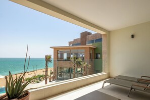 A balcony with a view of the sea, a potted plant, and a bed. - Dakhla South Bay, WorldHotels Distinctive (Dakhla)