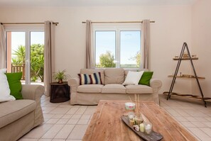 Relax in this stylish living room with a sofa, coffee table, and potted plant.