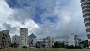 A cityscape with multiple high-rise buildings under a cloudy sky. - Casa Condado Hotel & Residences Rooftop Studio (San Juan)