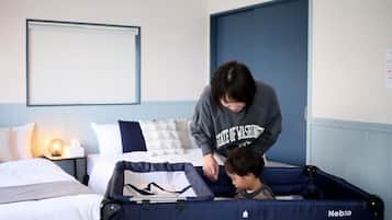 Cozy retreat with a comfortable bed and a convenient travel cot for little ones.