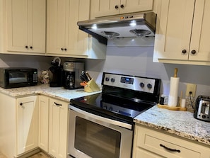 Fully equipped kitchen with double oven, microwave, and toaster.