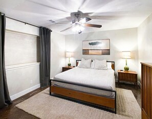 Cozy retreat with a single bed, bedside tables, and a ceiling fan.
