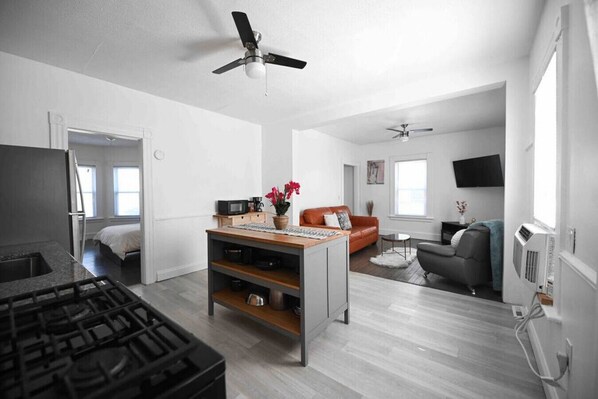 Een modern appartement met keuken, eetgedeelte, woonkamer en een slaapkamer.