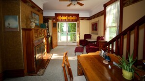 A spacious living room with a fireplace, wooden furniture, and a ceiling fan. - 4+ acres with 100 feet of sugar sand beach on Lake Huron (Cheboygan)