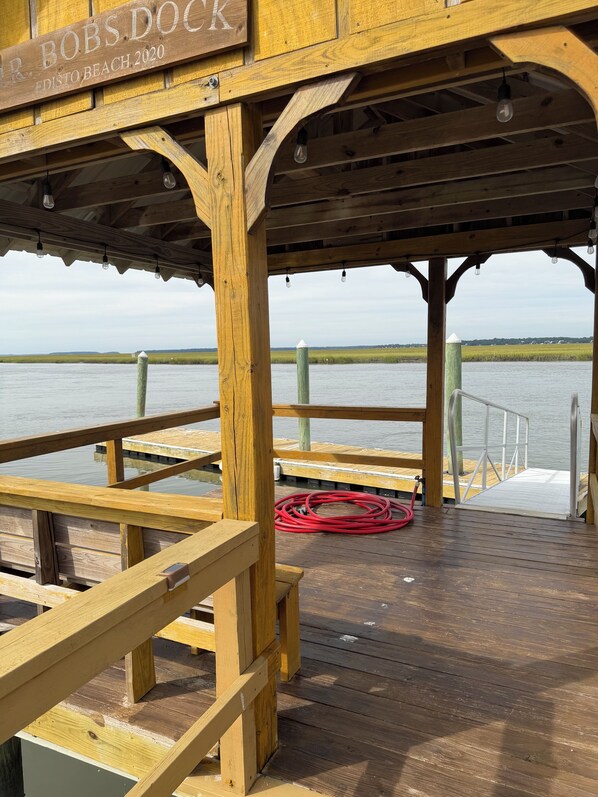A wooden dock with a sign reading 'Bobs Dock Edisto Beach 2020.'