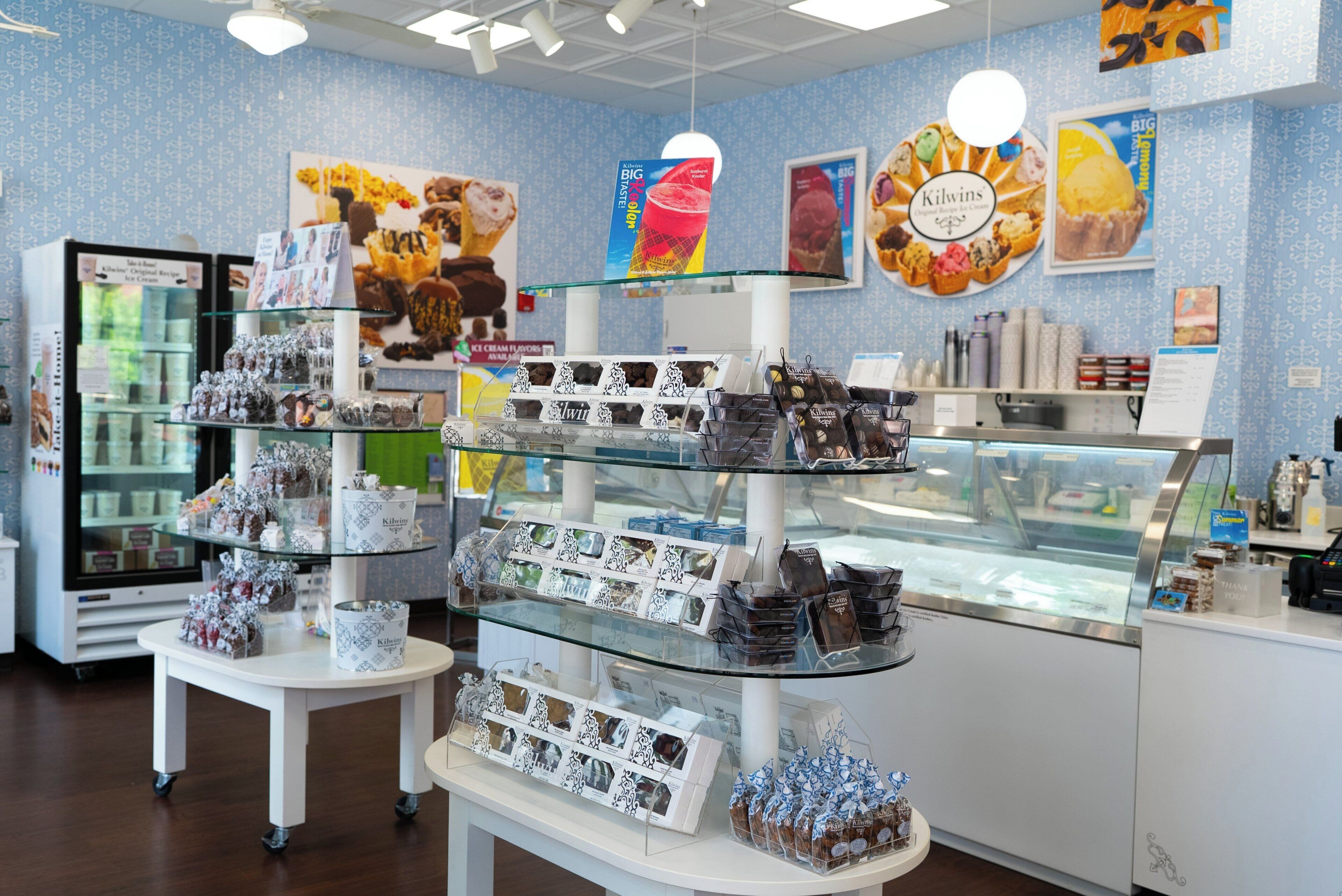 A bakery display with various baked goods and ice cream flavors.