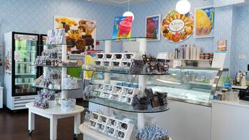 A bakery display with various baked goods and ice cream flavors.