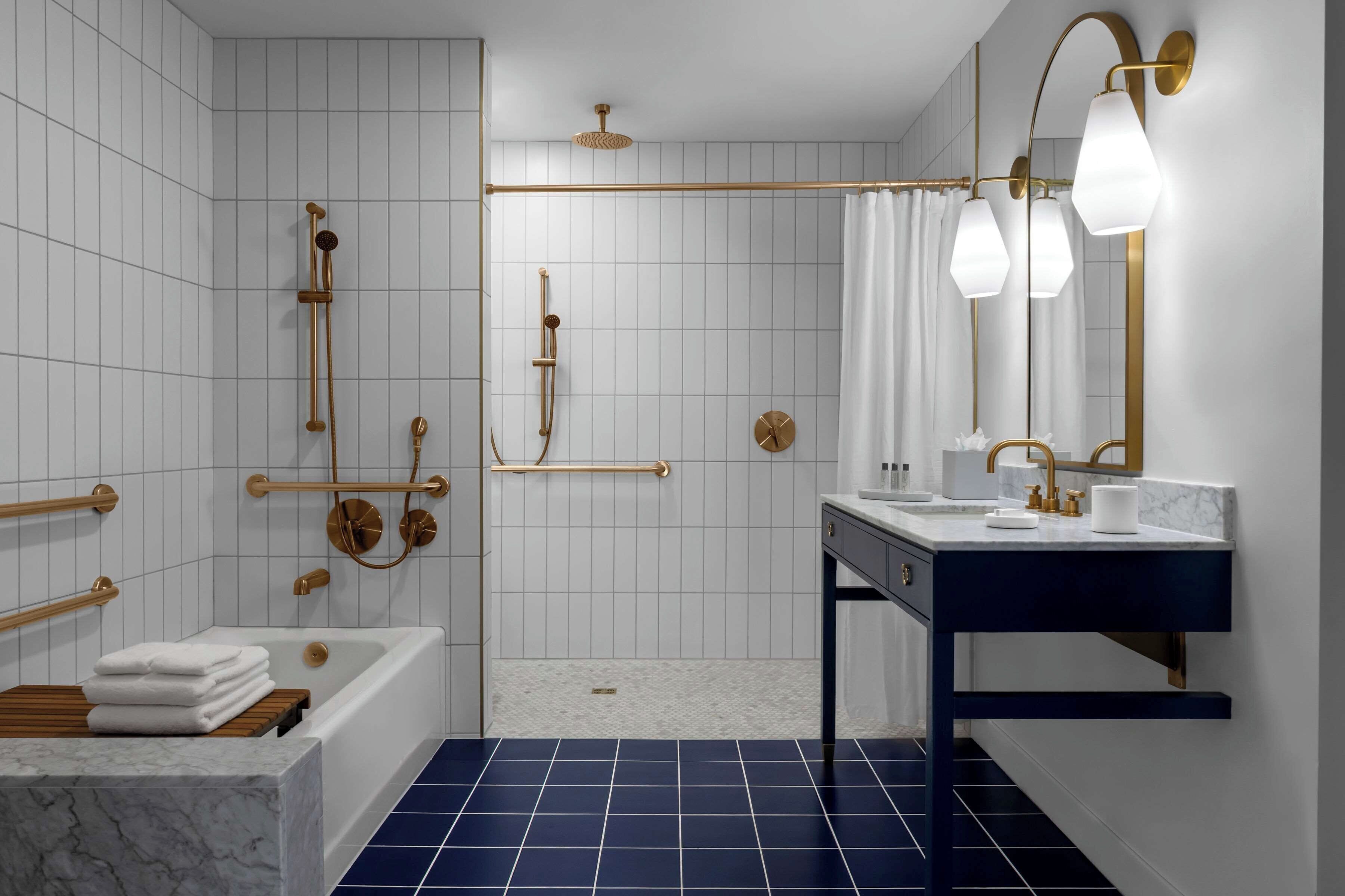 A modern bathroom with a bathtub, a shower area, and a vanity with a mirror.