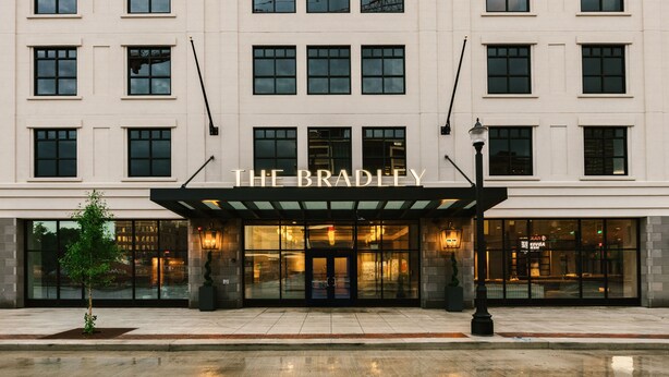 A hotel entrance with a large sign reading "THE BRADLEY". - The Bradley Hotel (Fort Wayne)