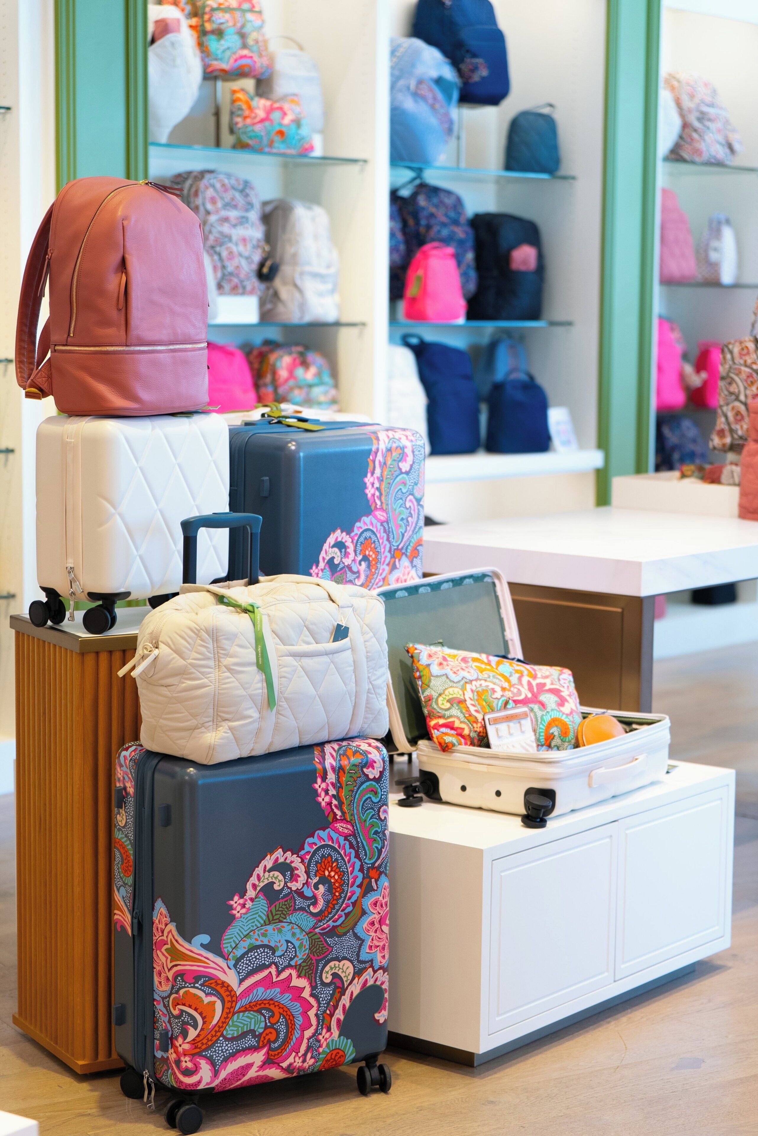 A luggage display with various suitcases and bags.